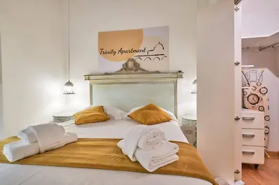 a bedroom with a bed with towels on it at Trinity Apartment in Rome