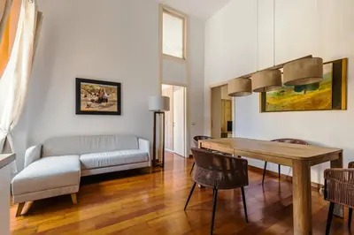 a living room with a table and a couch at Casa Vacanze Ottaviano 25 in Rome