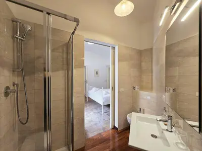 a bathroom with a shower and a sink at Cozy Colosseum 2BR-2BA Family Home in Rome