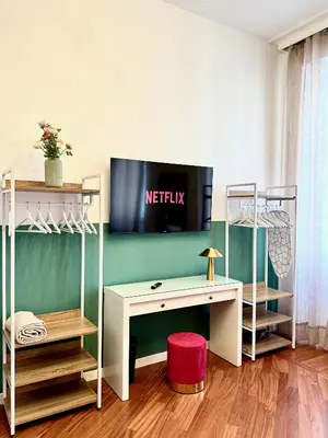 a room with a desk and a tv on the wall at Vacanze Romane Suite 7 Languages in Rome