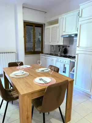 a kitchen with a wooden table with wine glasses on it at Cielo Aperto Bed and Breakfast in Rome