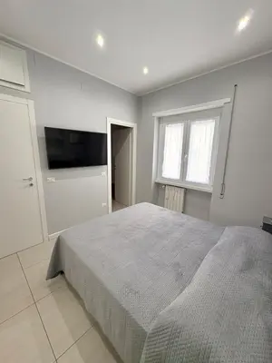 a bedroom with a bed and a flat screen tv at Fortis Domus in Rome