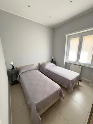 a bedroom with two beds and a window at Fortis Domus in Rome