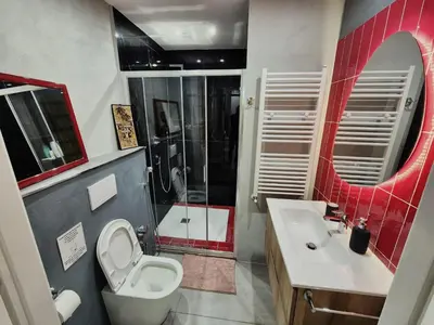 a kitchen with green cabinets and a glass table at Colosseum Apartment, 3 bedrooms, 3 baths, large living room with a sofa bed, the apartment can accommodate 8 people in Rome