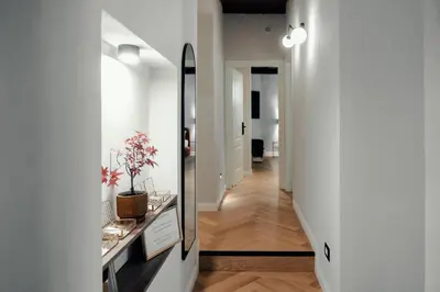 a hallway with a mirror and a hallway leading into a room at The Rubens Spagna in Rome