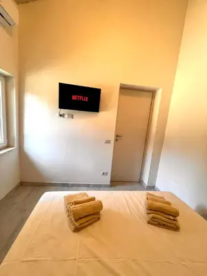 a room with a bed with three towels on it at Pigneto Holiday Home in Rome