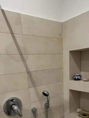 a shower with a shower head in a bathroom at 7550rome P&J's cozy Trastevere Apartment in Rome