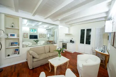 a living room with a couch and a table at Piazza Navona Ivy Retreat- Under the Roman Light in Rome