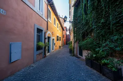 an alley between two buildings in a city at Piazza Navona Ivy Retreat- Under the Roman Light in Rome