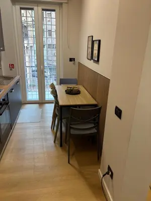 a kitchen and dining room with a table and chairs at Masonber trastevere centro Wi-Fi free balcone metro in Rome