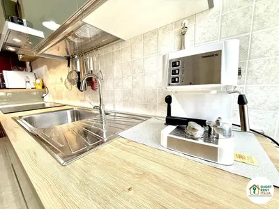 a kitchen with a sink and a microwave at San Giovanni - Minerva House in Rome