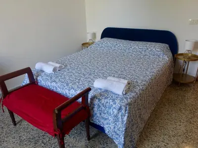 a bedroom with a bed and a red chair at PiccoloPrincipeAirbnb - Saint Peter area in Rome