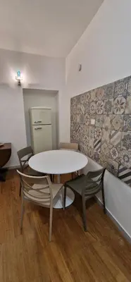 a room with a table and chairs and a refrigerator at PiccoloPrincipeAirbnb - Saint Peter area in Rome