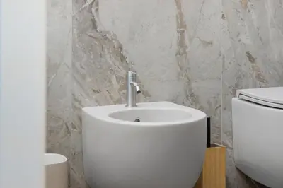 a bathroom with a white sink and a toilet at La Dimora di Piazza Mazzini in Rome