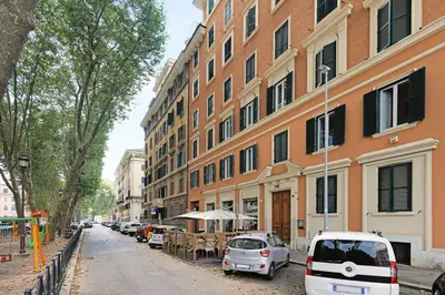a street with cars parked in front of a building at Piazza Mazzini Suite con Vasca Idromassaggio in Rome