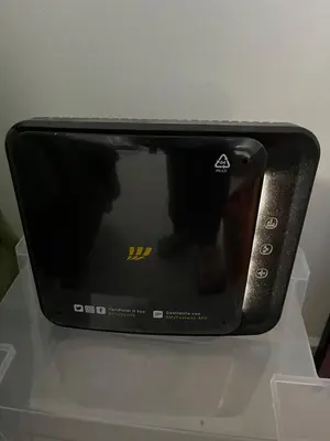 a black microwave sitting on top of a table at Terni 74 V&B Rock House in Rome