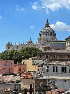 a view of a city with a dome in the background at San Pietro Charme in Rome
