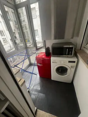a washing machine with a microwave on top of it at Mina's House in Rome
