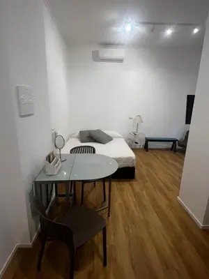 a bedroom with a bed and a table in a room at Mina's House in Rome