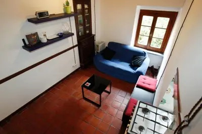 a living room with a blue couch and a table at 931 Rome Montefiore apartment in Rome