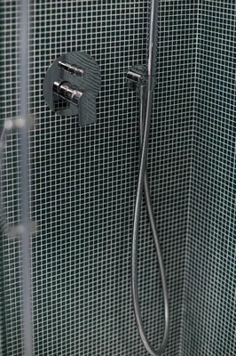a shower with a shower head on a tiled wall at Casina Albani in Rome