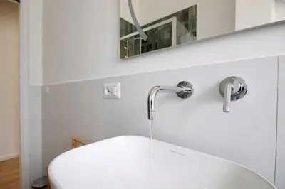 a bathroom with a white sink and a mirror at HC - Charming Apartment in Vigna Clara in Rome