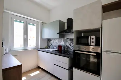 a kitchen with a stove and a microwave at HC - Charming Apartment in Vigna Clara in Rome