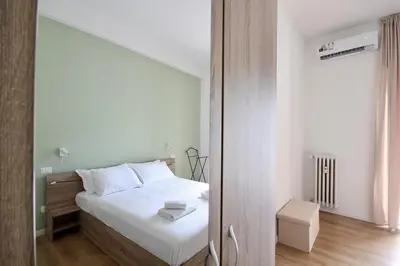 a bedroom with a white bed and a mirror at HC - Charming Apartment in Vigna Clara in Rome