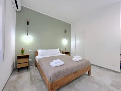 a bedroom with a bed with two towels on it at Casa della Musica - Guesthouse in Rome