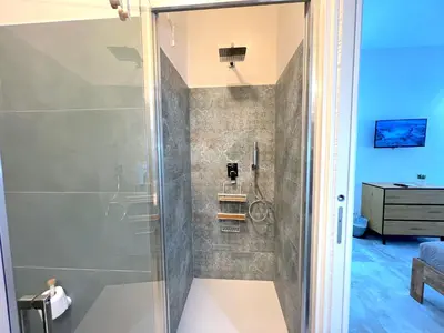 a shower with a glass door in a bathroom at Casa della Musica - Guesthouse in Rome