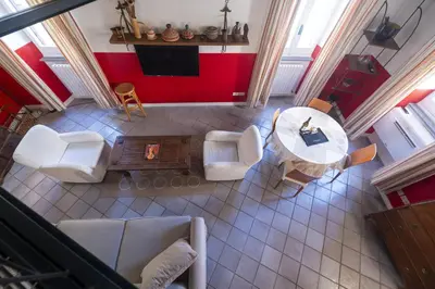 an overhead view of a living room with a table and chairs at The Scarlet Loft in Trastevere in Rome