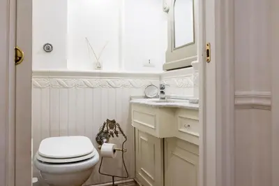 a bathroom with a toilet and a sink and a mirror at Candy Lodge in Rome