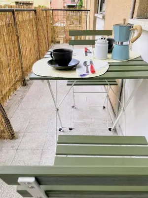 a table on a balcony with a table and chairs at Casa Troccoli in Rome