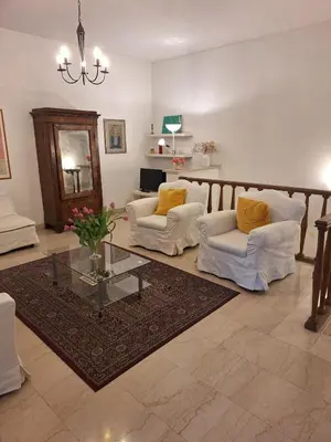 a living room with two chairs and a glass table at Apartment Rome Parioli near Villa Borghese in Rome