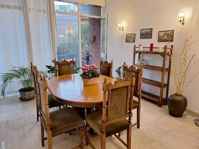 a dining room with a wooden table and chairs at Apartment Rome Parioli near Villa Borghese in Rome