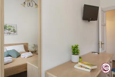a room with a bed and a table with a mirror at Domus Latina heart San Giovanni in Rome