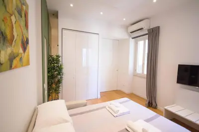 a white room with a table and a window at Corso 277 Apartment in Rome