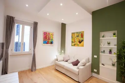 a living room with a couch and a window at Corso 277 Apartment in Rome