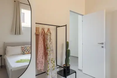 a mirror in a room with a bed and a cactus at iFlat Scenic Penthouse with Terrace near Vatican in Rome