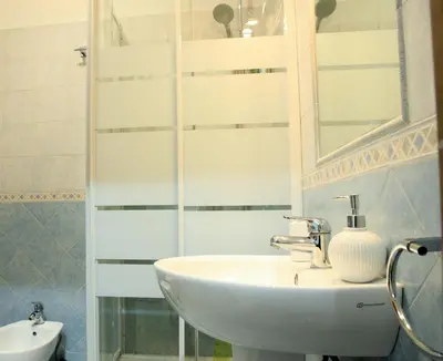 a bathroom with a sink and a mirror at Le tue Notti a San Pietro in Rome
