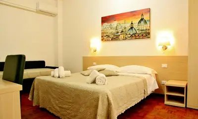 a hotel room with a bed with towels on it at Le tue Notti a San Pietro in Rome