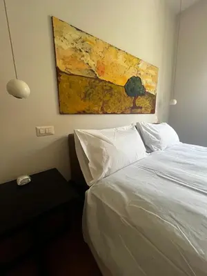 a bedroom with a bed and a painting on the wall at Casa Jacomini in Rome