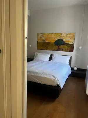 a bedroom with a bed with a painting on the wall at Casa Jacomini in Rome