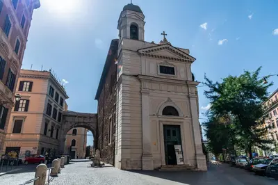 a building with a clock tower on a street at Boutique apartment 10 min to Colosseum and Termini in Rome