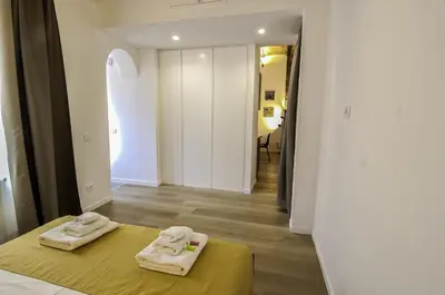 two towels are sitting on a bed in a room at Appartamento Pigneto in Rome