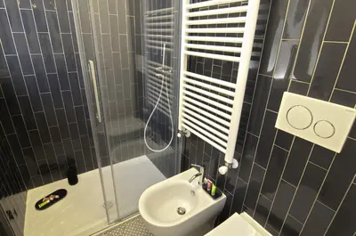 a bathroom with a shower and a toilet and a sink at Appartamento Pigneto in Rome