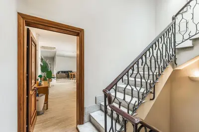 a hallway with a stairway leading to a living room at ATRHOME- Penthouse Tritone in Rome
