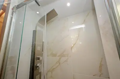 a bathroom with a shower with a glass door at Loft al Pantheon by Luxury Getaways in Rome