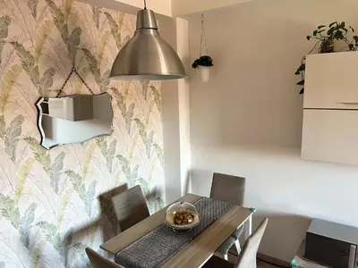 a dining room with a table and a wall at Casa di Ross in Rome