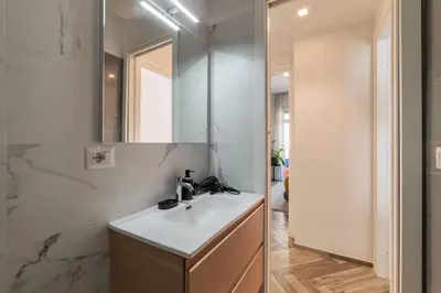 a bathroom with a sink and a mirror at GuestHost - Colorful Apt in Vintage-Modern Style in Rome
